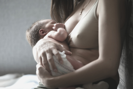 woman breastfeeding new baby