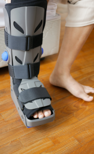 An injured foot in a surgical walking boot for an Achilles tendon injury